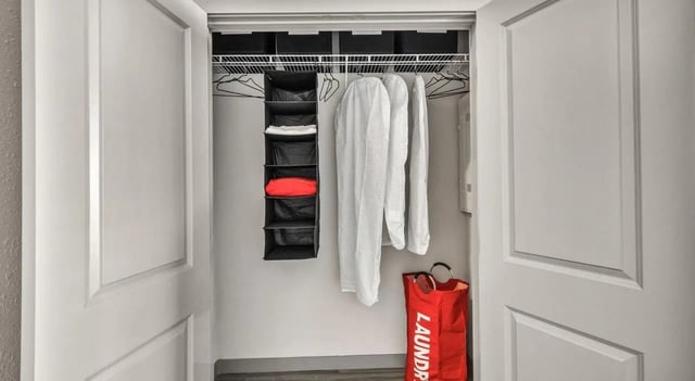 Closet with hanging storage laundry bag closet at Haven At Elgin in Houston Student Accommodation