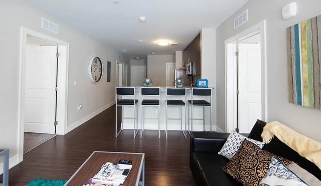 Modern apartment with kitchen island couch living room at Park Place Columbia in Columbia Student Accommodation