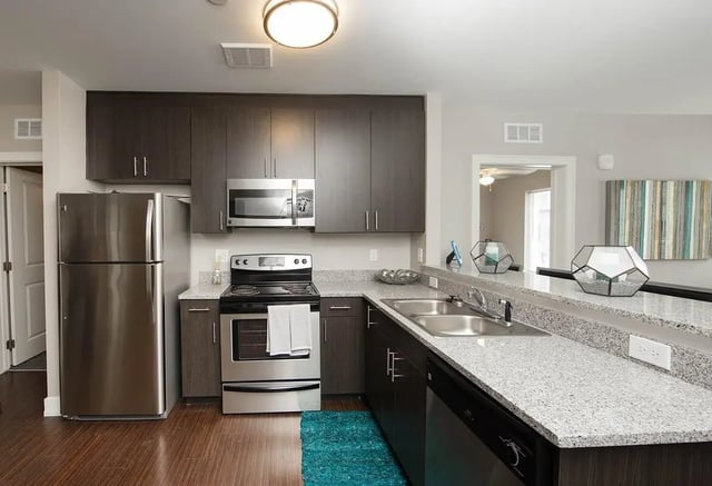 Stainless steel refrigerator stove microwave granite counters kitchen at Park Place Columbia in Columbia Student Accommodation