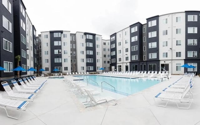 Apartment complex with pool and lounge chairs exterior at Park Place Columbia in Columbia Student Accommodation