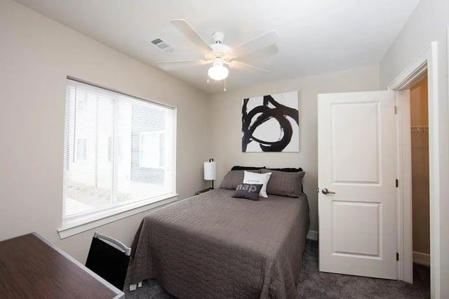 Bed with pillows desk and chair Bedroom at Park Place Columbia in Columbia Student Accommodation