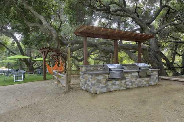 Outdoor grills lounge chairs and picnic tables exterior at Mustang Village Apartments in San Luis Obispo Student Accommodation