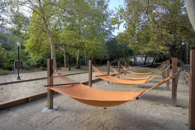 Hammocks strung between wooden posts recreation area at Mustang Village Apartments in San Luis Obispo Student Accommodation