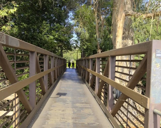Bridge with people walking outdoors exterior at Mustang Village Apartments in San Luis Obispo Student Accommodation