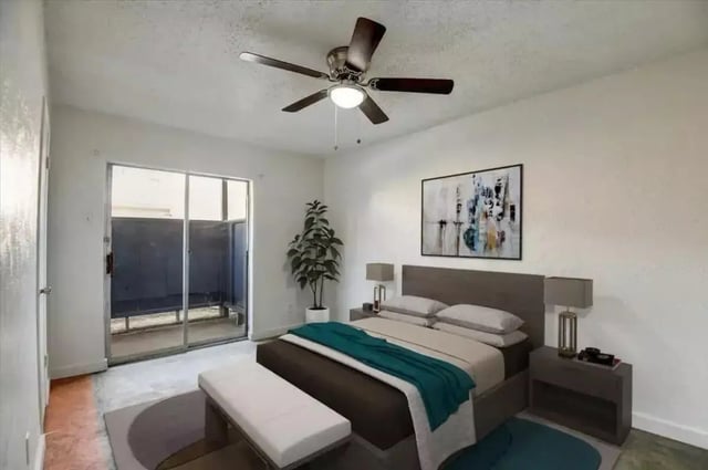 Bed ceiling fan plant artwork and bench bedroom at Starlite Apartments in Denton Student Accommodation