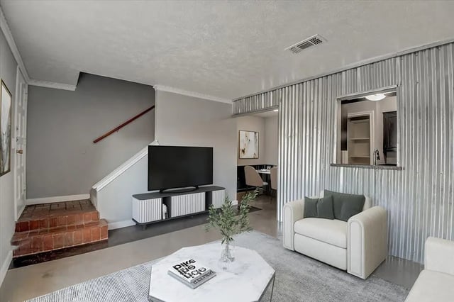 Sofa tv stairs dining area living room at Starlite Apartments in Denton Student Accommodation