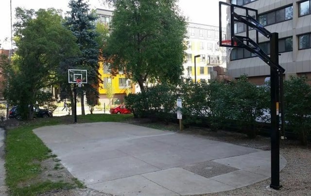 Basketball court with hoop and buildings exterior at Chateau Student Housing Co-op in Minneapolis Student Accommodation