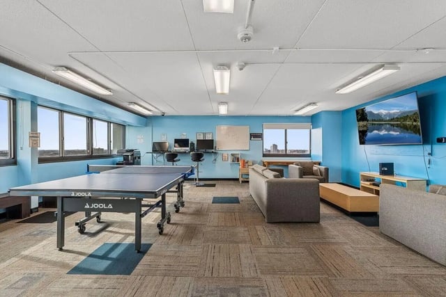 Ping pong table computers couches and TV common area at Chateau Student Housing Co-op in Minneapolis Student Accommodation