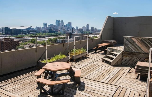 Picnic tables planters wooden deck cityscape exterior at Chateau Student Housing Co-op in Minneapolis Student Accommodation