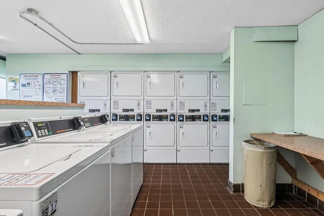 Row of washers and dryers laundry room at Chateau Student Housing Co-op in Minneapolis Student Accommodation