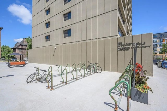 Bicycles and planters outside building exterior at Chateau Student Housing Co-op in Minneapolis Student Accommodation