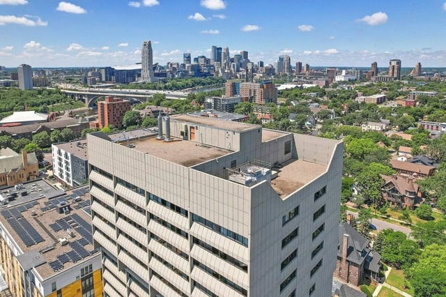 Building exterior with city skyline and solar panels Exterior at Chateau Student Housing Co-op in Minneapolis Student Accommodation