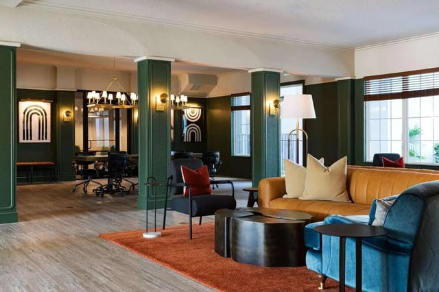 Sofa chairs coffee table rug meeting room living area at 4050 Lofts in Tampa Student Accommodation