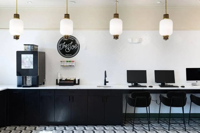 Coffee machine computers sink and black cabinets common area at 4050 Lofts in Tampa Student Accommodation