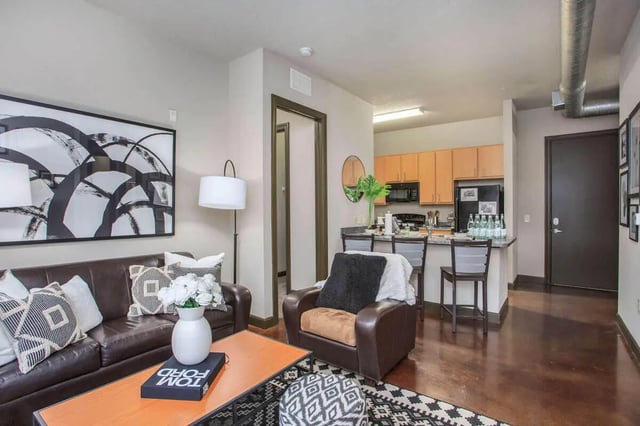 Brown sofa and chairs with modern art living room at 4050 Lofts in Tampa Student Accommodation