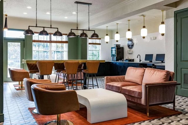Bar with chairs couches computers coffee maker lounge at 4050 Lofts in Tampa Student Accommodation