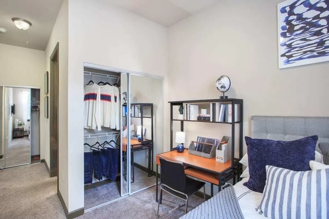 Closet desk bed with globe painting bedroom at 4050 Lofts in Tampa Student Accommodation