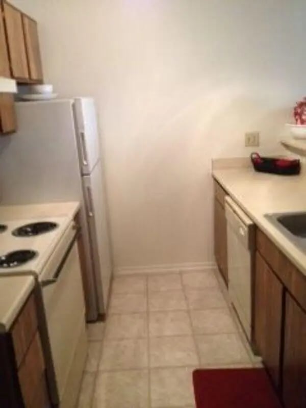 Refrigerator stove dishwasher cabinets kitchen at Baylor Plaza III in Waco Student Accommodation