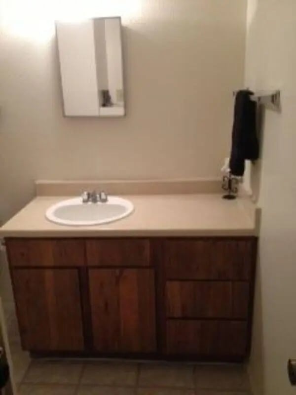 Sink vanity mirror medicine cabinet bathroom at Baylor Plaza III in Waco Student Accommodation