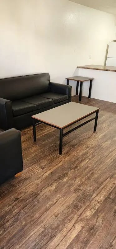Black sofa two coffee tables living room at Baylor Plaza III in Waco Student Accommodation