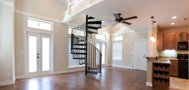 Spiral staircase with kitchen and doors interior at Archstone Luxury Apartments in Gainesville Student Accommodation
