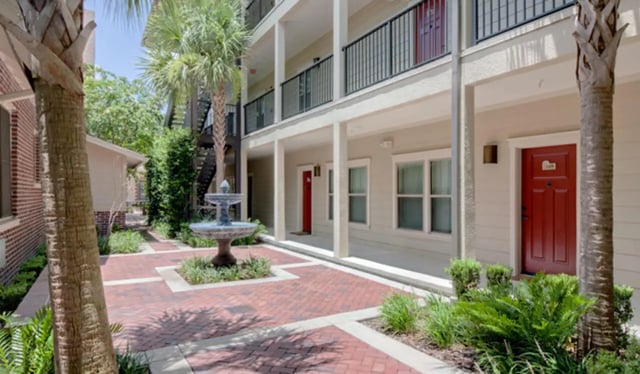 Fountain building with red doors and balconies exterior at Archstone Luxury Apartments in Gainesville Student Accommodation