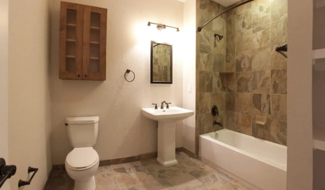 Toilet sink tub wooden cabinet Bathroom at Archstone Luxury Apartments in Gainesville Student Accommodation