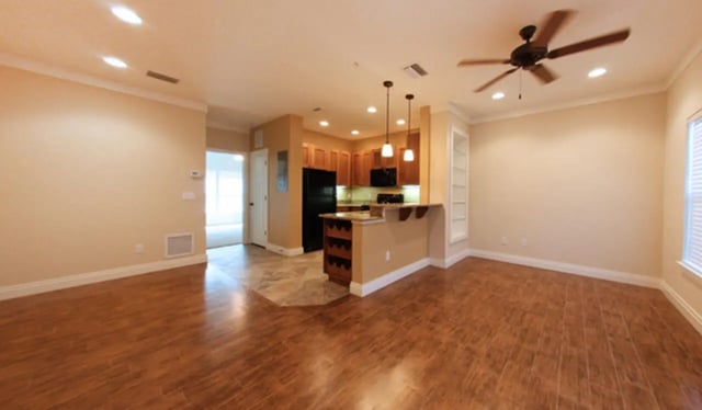 Kitchen with island and open living space living room at Archstone Luxury Apartments in Gainesville Student Accommodation