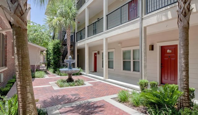 Courtyard with fountain red doors balconies exterior at Archstone Luxury Apartments in Gainesville Student Accommodation