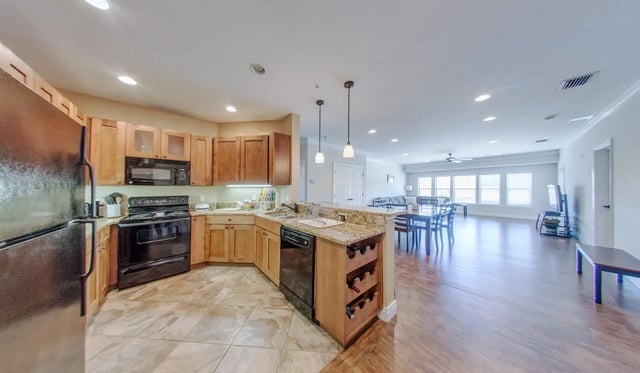 Kitchen with refrigerator stove and dining area at Archstone Luxury Apartments in Gainesville Student Accommodation