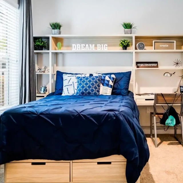 Bed with blue bedding and built-in shelves bedroom at Halo 46 Apartments in Tampa Student Accommodation