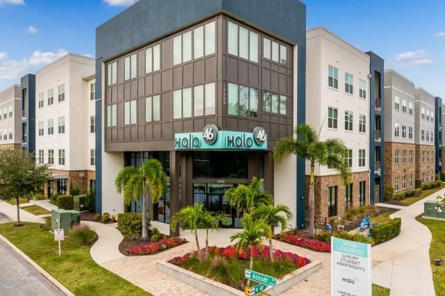 Modern apartments with palm trees exterior at Halo 46 Apartments in Tampa Student Accommodation