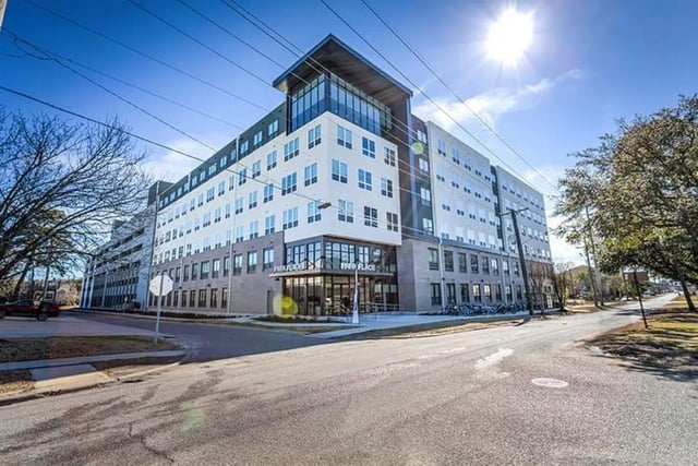 Modern apartment building with large windows and bikes exterior at Park Place Baton Rouge in Baton Rouge Student Accommodation