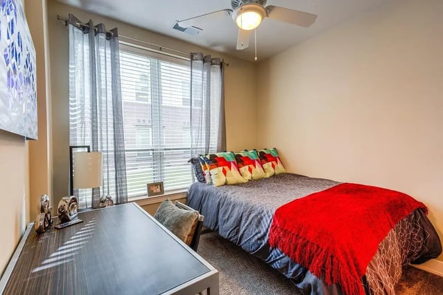 Desk bed with colorful pillows and red throw Bedroom at Park Place Baton Rouge in Baton Rouge Student Accommodation