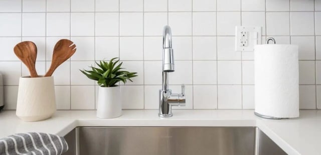 Wooden spoons plant faucet paper towel kitchen at Addams Coliving in Chicago Student Accommodation