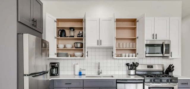 Fridge cabinets microwave appliances and stove kitchen at Addams Coliving in Chicago Student Accommodation