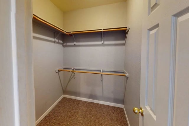 Empty closet with shelves and hanging rods closet at Bear Crossing Apartments in Waco Student Accommodation