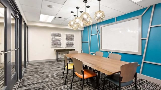 Conference table with chairs and whiteboard Meeting room at Varsity on K Apartments in Washington Student Accommodation