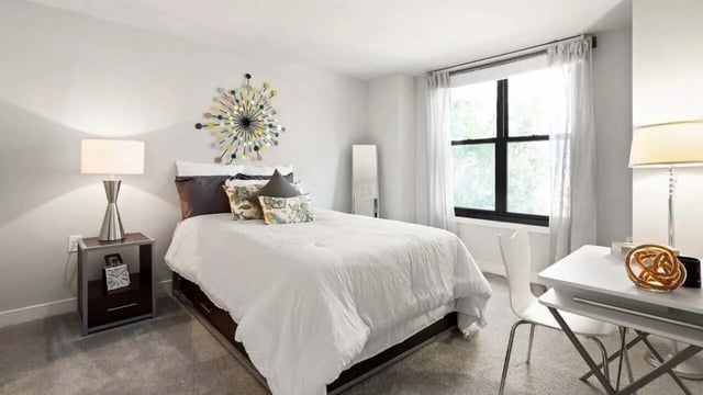 Bed nightstand lamp mirror and desk bedroom at Varsity on K Apartments in Washington Student Accommodation