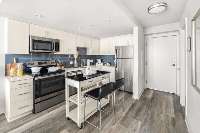 Modern kitchen with island and bar stools kitchen at Varsity on K Apartments in Washington Student Accommodation