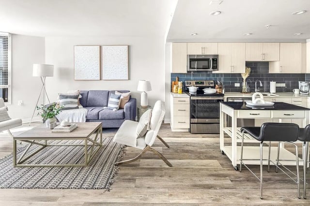 Sofa kitchen island and appliances living kitchen at Varsity on K Apartments in Washington Student Accommodation