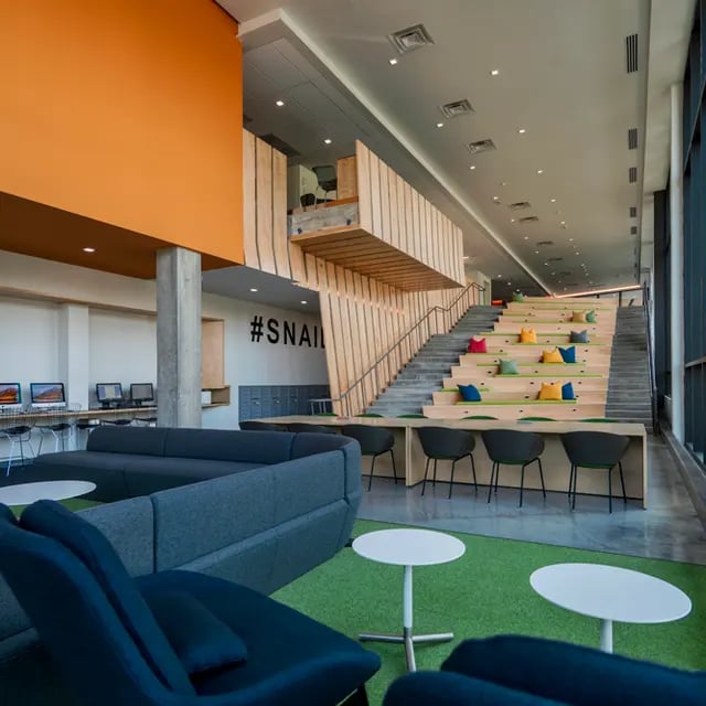 Modern communal study lounge with tiered seating living area at 505 on Walnut Apartments in Syracuse Student Accommodation