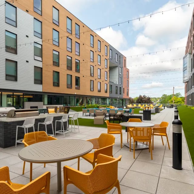 Outdoor seating and grill area exterior at 505 on Walnut Apartments in Syracuse Student Accommodation