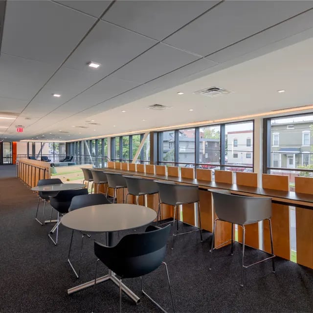 Study tables chairs and lounge area common area at 505 on Walnut Apartments in Syracuse Student Accommodation