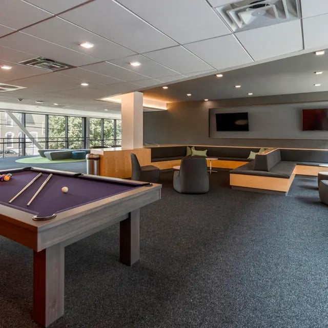Pool table lounge seating and TVs communal area at 505 on Walnut Apartments in Syracuse Student Accommodation