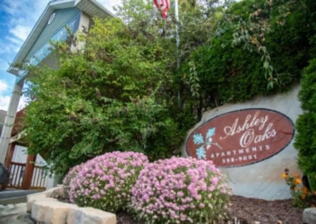 Ashley Oaks Apartments sign pink flowers exterior at Ashley Oaks Apartments in Morgantown Student Accommodation