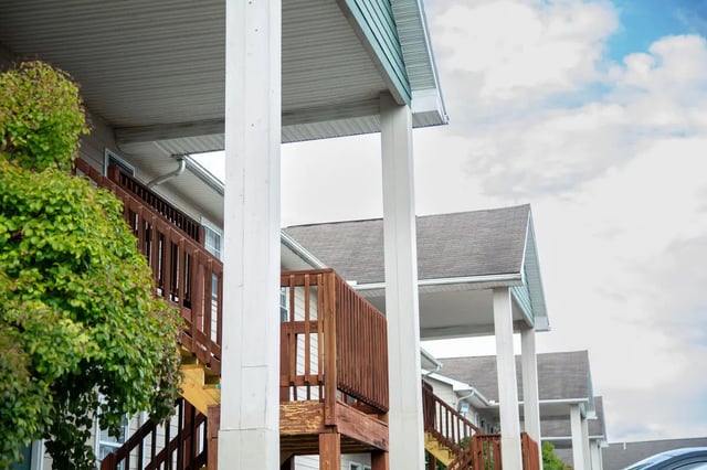 Wooden stairs and balconies lead to apartments exterior at Ashley Oaks Apartments in Morgantown Student Accommodation