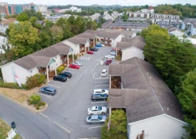 Apartment buildings with cars parked in lot exterior at Ashley Oaks Apartments in Morgantown Student Accommodation