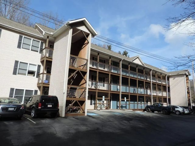Apartment building with balconies and parking exterior at The Exchange Apartments of Boone in Boone Student Accommodation