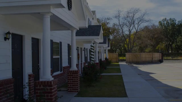 Apartment building row with porches and landscaping exterior at The Estate on Third in Waco Student Accommodation